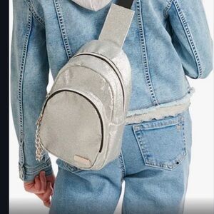 Like New Justice sling bag. Silver and‎ Black.